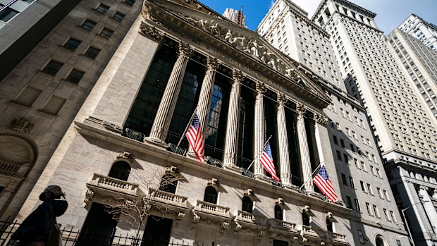 A pedestrian walks past the New York Stock Exchange.