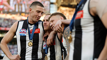 Darcy Cameron, Tom Mitchell and Jordan De Goey of the Magpies celebrate after the 2023 AFL grand final. 