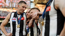 Darcy Cameron, Tom Mitchell and Jordan De Goey of the Magpies celebrate after the 2023 AFL grand final. 