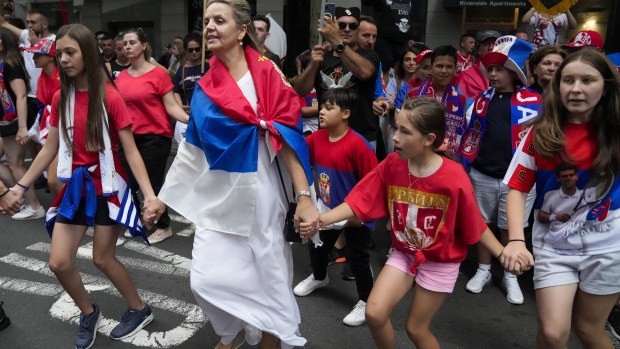 Fans dance and sing outside an immigration detention hotel where Serbian Novak Djokovic is confined in Melbourne.