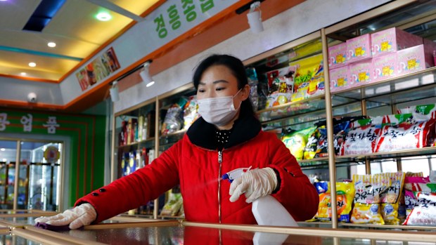 An employee of the Kyonghung Foodstuff General Store disinfects the showroom countertops in Pyongyang, North Korea in November 2021.