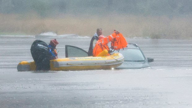 A man is rescued from his car by State Emergency Service workers in Windsor, Sydney.
