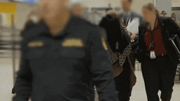 A so-called ISIS bride is escorted into custody by federal officers.