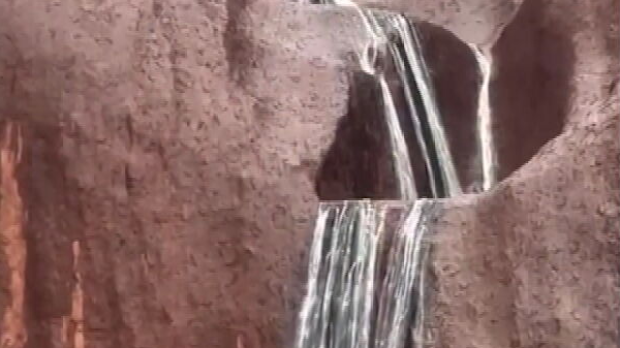 Waterfalls pour off Uluru after record rain | Nine.com.au