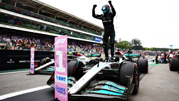 George Russell stands atop his W13 after winning the Brazilian Grand Prix.