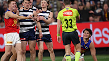 Lions player Cam Rayner is awarded a free kick against Zach Guthrie of the Cats during the second qualifying final.