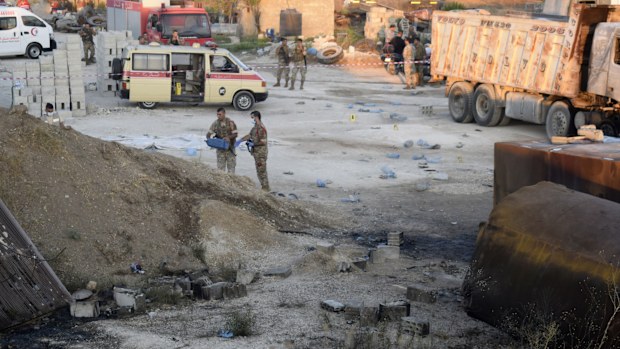 Lebanese soldiers investigate next to fuel tankers that were exploded in Tleil village.