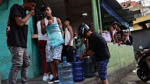 CARACAS, VENEZUELA - JANUARY 03: People buy bottled water after explosions and low-flying aircraft were heard in the early hours on January 03, 2026 in Caracas, Venezuela. According to some reports, explosions were heard in Caracas and other cities near airports and military bases around 2 am. US President Donald Trump later announced that his country's military had launched a "large-scale" attack on Venezuela and captured its President Nicolas Maduro and his wife.