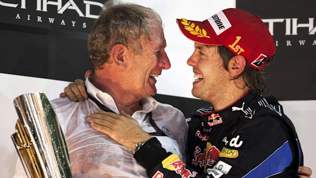 Red Bull Racing's Helmut Marko celebrates on the winners podium with Sebastian Vettel in 2010.