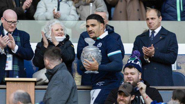 Scotland's Sione Tuipulotu with his gran Jaqueline Thomson as Phil Waugh watches on.