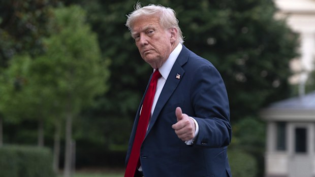 President Donald Trump gives a thumbs up to reporters as he walks on the South Lawn upon arriving at the White House, Sunday, July 13, 2025, in Washington. (AP Photo/Jose Luis Magana)