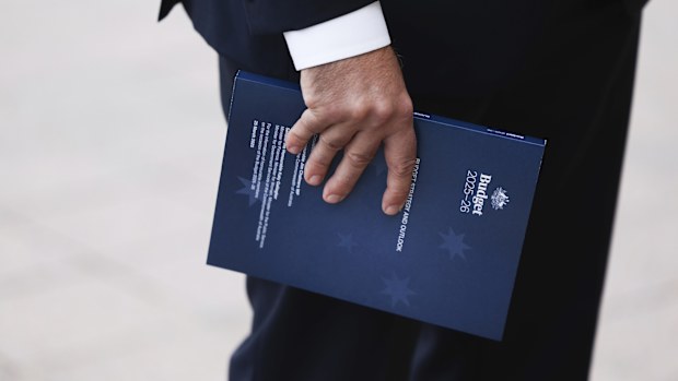 Budget documents in the hand of Treasurer Dr Jim Chalmers during a doorstop interview ahead of handing down the 2025-26 Federal Budget, at Parliament House in Canberra on Tuesday 25 March 2025.