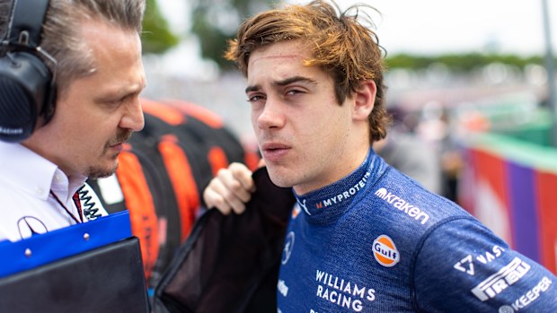 Franco Colapinto talks with his race engineer on the grid ahead of the Brazilian Grand Prix.