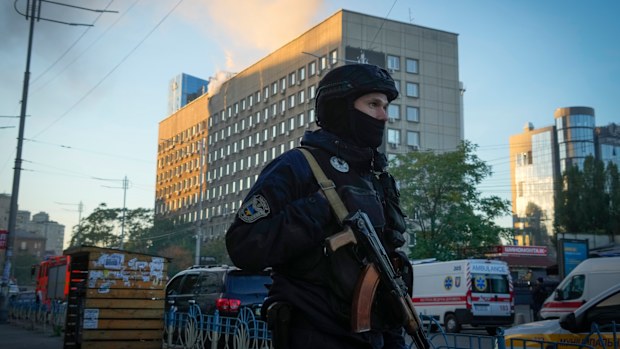 Police block the perimeter at the scene of Russian shelling in Kyiv on Monday, October 17.
