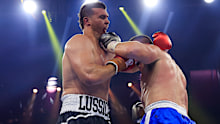 Paul Gallen (R) lands a punch on the jaw of Darcy Lussick.