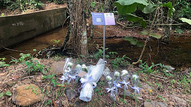 Flowers are placed at the scene where a woman was found dead a day earlier at a secluded spot on the southern island of Phuket, Thailand.