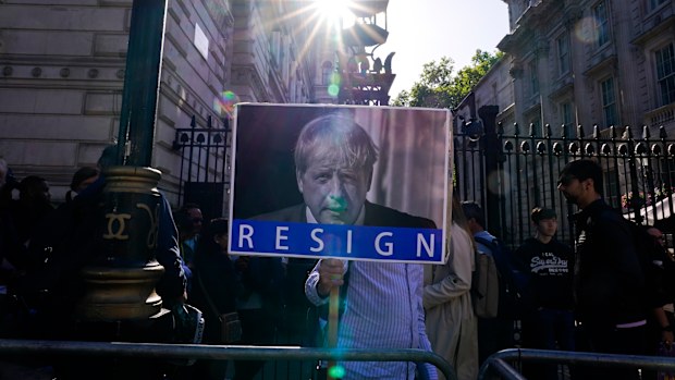 A demonstrator holds a placard depicting Britain's Prime Minister Boris Johnson after an investigative report blamed Johnson and other senior leaders for allowing government parties that broke the UK's COVID-19 lockdown rules. 