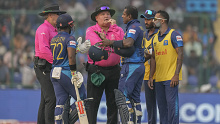 Sri Lanka's Angelo Mathews, third right, talks to umpires after he was declared timed out during the ICC Men's Cricket World Cup match between Bangladesh and Sri Lanka in New Delhi, India, Monday, Nov. 6, 2023. (AP Photo/Manish Swarup)