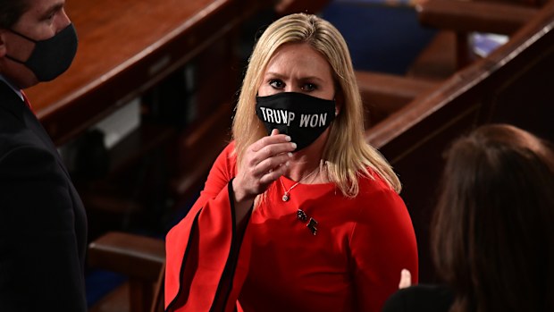 Rep. Marjorie Taylor Greene, R-Ga., wears a "Trump Won" face mask as she arrives on the floor of the House to take her oath of office on opening day of the 117th Congress at the U.S. Capitol in Washington, Sunday, Jan. 3, 2021. 