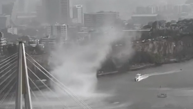 Incredible vision showed a gustnado rip through the Brisbane River during a dangerous storm cell over the city this afternoon.