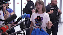 Activist Greta Thunberg answers reporters as she arrives from Israel at Charles de Gaulle airport, north of Paris, Tuesday, June 10, 2025 
