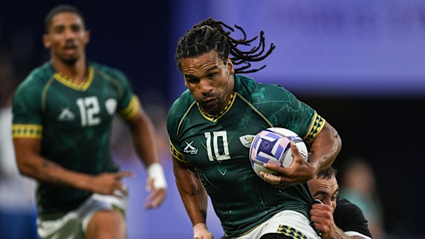 Rosko Specman of South Africa is tackled by Joe Webber of New Zealand.