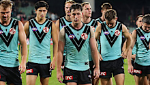 Zak Butters leads the team off after the loss.