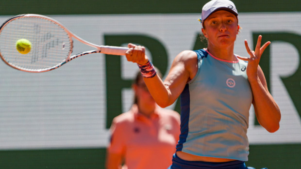 Iga Swiatek hits a forehand at Roland-Garros.