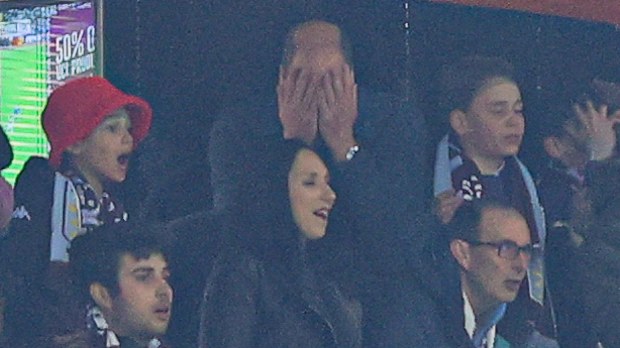 William, Prince of Wales, reacts after a missed chance with son George.