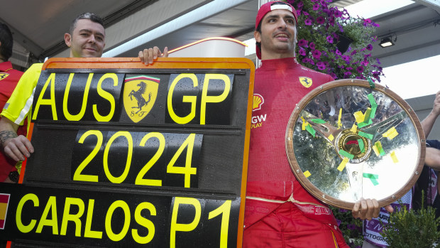Ferrari driver Carlos Sainz of Spain poses with his trophy after winning the Australian Grand Prix at Albert Park.