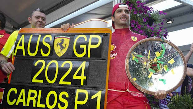 Ferrari driver Carlos Sainz of Spain poses with his trophy after winning the Australian Grand Prix at Albert Park.