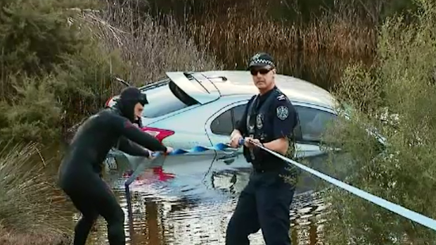 Police spent the afternoon retrieving the submerged Lancer and collecting it as evidence.