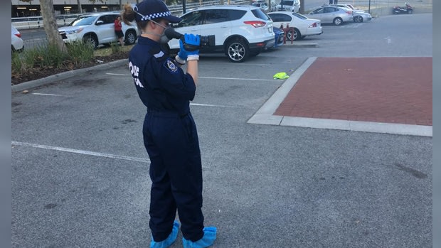 Police examine the site outside Officeworks in East Perth, where the man was Tasered.