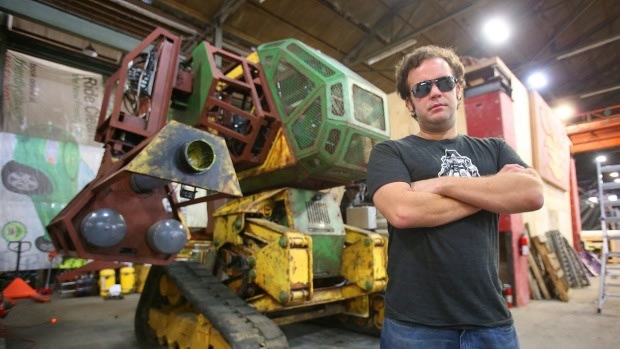 Megabots co-founder Gui Cavalcanti in front of his Mk II robot.