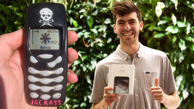 Oly with his new Google Pixel phone and, left, holding his old Nokia.