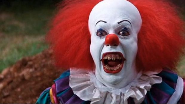 Tim Curry as Pennywise in the 1990 It miniseries.