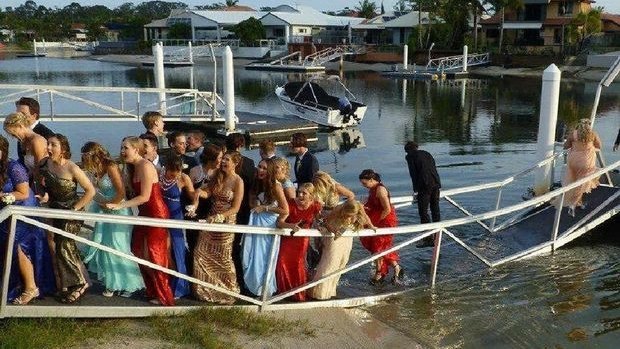 A canal bridge collapses under the weight of Maroochydore State High students prior to their formal.
