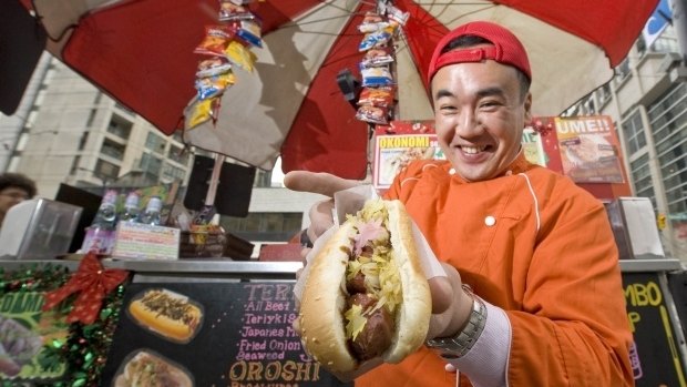 Japadog founder Noriki Tamura serves up a pork hot dog.