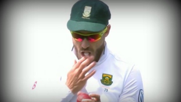 Du Plessis seen rubbing the ball with a mint in his mouth.