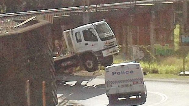 A garbage truck snagged by the Blackall Street underpass at Woombye, on the Sunshine Coast line.