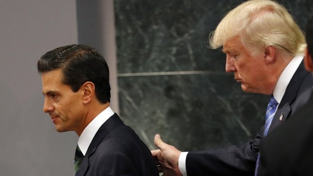 Republican presidential nominee Donald Trump walks with Mexico President Enrique Pena Nieto at the end of their joint statement in Mexico City.