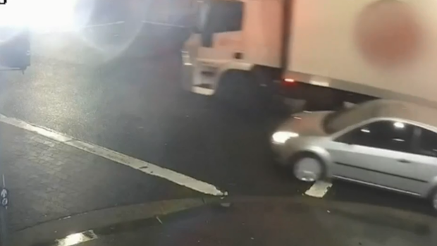 The car pulls out of a parked lane, turns a corner and is scraped. 