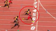 Noah Lyles (red top) glares at sprint rival Kenny Bednarek as they cross the finish line.