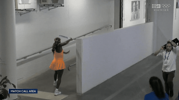 Coco Gauff smashes her racquet in the players area.