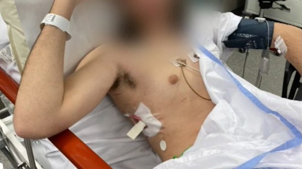 The 15-year-old boy was hospitalised with a stab wound to the torso after a man allegedly broke into the Gold Coast unit in Varsity Lakes about 1am armed with a golf club and knife, according to police.
