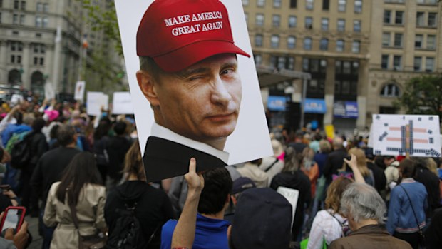  A demonstrator holds up a sign of Vladimir Putin during an anti-Trump 'March for Truth' rally on June 3, 2017 in New York City.