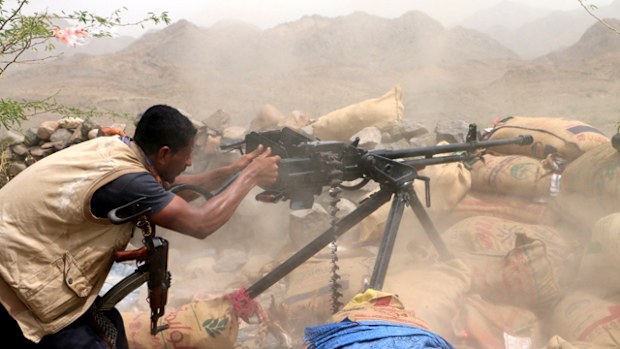  A member of Yemeni government forces fires a heavy machine gun during an offensive against Houthi positions on the outskirts of the western port city of Hodeidah, Yemen. (AAP)