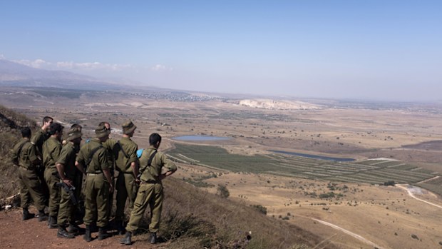 Israeli soldiers look out towards Syria from an observation next to the Syrian border on July 23, 2018 in Golan Hights, Israel. Russian planes bombed the Israeli-Syrian border as part of the continued fighting in Syria. (Getty)