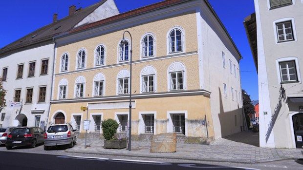 A memorial stone made out of granite from Mauthausen stands in front of the house in Braunau where Adolf Hitler was born