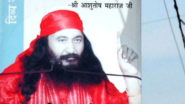 A billboard illustration of Indian spiritual leader Ashutosh Maharaj, whose body has been frozen by his devotees. (Getty)